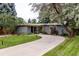 Inviting single-story home with a curved driveway, mature trees, and well-maintained landscaping at 1338 S Fairfax St, Denver, CO 80222