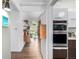 Bright hallway with wood floors that lead to the main living area at 1338 S Fairfax St, Denver, CO 80222