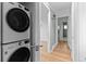 Hallway with laundry room featuring a stackable washer and dryer set at 1338 S Fairfax St, Denver, CO 80222
