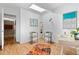 Sunlit home office with skylight, desk, and wood flooring at 1338 S Fairfax St, Denver, CO 80222