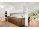 Modern kitchen with sleek cabinetry, marble countertops, and stainless steel appliances, open to the living area at 1338 S Fairfax St, Denver, CO 80222