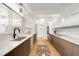 Bright kitchen featuring two-tone cabinets, marble countertops, stainless steel appliances, and stylish lighting at 1338 S Fairfax St, Denver, CO 80222