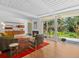 Well-lit living room with hardwood floors, fireplace, and sliding door access to the backyard at 1338 S Fairfax St, Denver, CO 80222