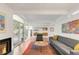 Bright living room with a fireplace, sliding glass doors to the backyard, and cozy seating area at 1338 S Fairfax St, Denver, CO 80222