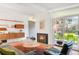 Cozy living room featuring a fireplace, large windows, and stylish decor for a warm and inviting space at 1338 S Fairfax St, Denver, CO 80222