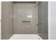 Tiled shower with gray subway tiles, built-in niche, and bronze fixtures at 1338 S Fairfax St, Denver, CO 80222