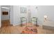 Bright sitting area featuring hardwood floors, two chairs, area rug, and a white desk at 1338 S Fairfax St, Denver, CO 80222