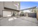 Spacious backyard with a gated patio area, a garage door and a metal pergola at 2922 W 26Th Ave # 1, Denver, CO 80211