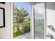 Open balcony overlooking lush greenery, with a tiled floor and iron railing at 2922 W 26Th Ave # 1, Denver, CO 80211