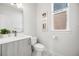 Bright half-bathroom with clean lines, modern fixtures, and a stylish vanity with marble floors at 2922 W 26Th Ave # 1, Denver, CO 80211