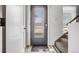 Light-filled entryway featuring a frosted glass front door, carpeted stairs, and a wooden floor at 2922 W 26Th Ave # 1, Denver, CO 80211