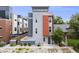 Contemporary home with a grey exterior and a pop of color with an orange section by the entrance at 2922 W 26Th Ave # 1, Denver, CO 80211