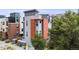 Three story grey home with an orange section next to the front door, with parking in the back at 2922 W 26Th Ave # 1, Denver, CO 80211