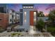 Contemporary home with a grey exterior and a pop of color with an orange section by the entrance at 2922 W 26Th Ave # 1, Denver, CO 80211