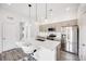 Modern kitchen boasts stainless steel appliances, island seating, and light wood cabinetry at 2922 W 26Th Ave # 1, Denver, CO 80211