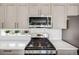 Gas range and stainless microwave are showcased amongst the modern kitchen appliances at 2922 W 26Th Ave # 1, Denver, CO 80211