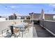 Charming rooftop patio setup with dining table, grill, and decorative string lights at 2922 W 26Th Ave # 1, Denver, CO 80211