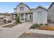 Charming two-story home with a welcoming front porch, landscaped yard, and a convenient attached carport at 9396 Bear River St, Littleton, CO 80125