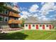 Manicured lawn and a versatile building with multiple red doors create a functional outdoor space at 1203 6Th St # 1203, Golden, CO 80403
