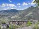 Apartment building with mountain views, blue sky, and scattered white clouds on a sunny day at 1203 6Th St # 1203, Golden, CO 80403