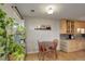 Dining area and kitchen with wood cabinets, stone backsplash, and decorative plants at 1203 6Th St # 1203, Golden, CO 80403