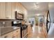 Updated kitchen with wood cabinets, stainless appliances, and wood flooring next to dining area at 1203 6Th St # 1203, Golden, CO 80403