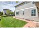 Backyard view showcasing a green lawn, well-manicured garden beds, and a brick pathway leading to the house at 22898 Addington Pl, Parker, CO 80138