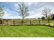 Expansive backyard featuring a well-maintained lawn and a wooden fence overlooking a scenic golf course at 22898 Addington Pl, Parker, CO 80138