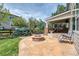 Landscaped backyard area with fire pit and covered patio featuring built-in grill at 22898 Addington Pl, Parker, CO 80138