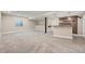 Expansive basement area with a bar, pendant lighting, and neutral carpet flooring at 22898 Addington Pl, Parker, CO 80138