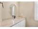 Bathroom featuring an oval mirror above a white vanity with a marble countertop and undermount sink at 22898 Addington Pl, Parker, CO 80138