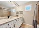 Bathroom featuring double sinks, a large mirror, and a shower with a shower curtain at 22898 Addington Pl, Parker, CO 80138