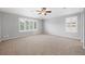 Spacious bedroom featuring a ceiling fan and light gray walls, complemented by large windows with plantation shutters at 22898 Addington Pl, Parker, CO 80138
