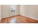 Bright bedroom featuring hardwood floors and a window with classic white shutters allowing natural light at 22898 Addington Pl, Parker, CO 80138