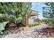 Charming home exterior with stone accents, lush landscaping, and a cozy fire pit area, ideal for outdoor living at 22898 Addington Pl, Parker, CO 80138
