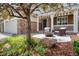 Inviting covered porch with comfortable seating, mature landscaping, and stone accents at 22898 Addington Pl, Parker, CO 80138
