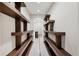 Hallway featuring custom shelving and decorative tile leading to the bathroom at 22898 Addington Pl, Parker, CO 80138