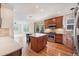 Bright kitchen featuring wood cabinets, an island with seating, and stainless steel appliances at 22898 Addington Pl, Parker, CO 80138