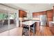 Well-equipped kitchen with wood cabinets, stainless steel appliances, and sliding door access to the patio at 22898 Addington Pl, Parker, CO 80138
