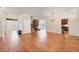 Open-concept living room with hardwood floors, fireplace, and access to the kitchen at 22898 Addington Pl, Parker, CO 80138