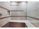 Contemporary shower featuring patterned tile, a built-in bench, and recessed niche at 22898 Addington Pl, Parker, CO 80138