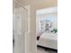 Modern bath featuring glass enclosed shower and view to bedroom at 1954 S Poplar Ct, Denver, CO 80224