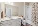Bathroom with a shower-tub combo, large mirror, and white vanity at 1954 S Poplar Ct, Denver, CO 80224