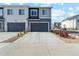 Newer two-story townhouse with gray siding and a two-car garage at 1954 S Poplar Ct, Denver, CO 80224
