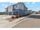Newer two-story townhouse with gray siding, blue accents, and a two-car garage at 1954 S Poplar Ct, Denver, CO 80224