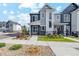Charming two-story home with a well-maintained lawn, landscaped with plants, and a black metal fence at 1954 S Poplar Ct, Denver, CO 80224