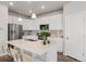 Modern kitchen with a spacious island, white cabinetry, stainless steel appliances, and hardwood floors at 1954 S Poplar Ct, Denver, CO 80224
