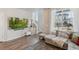 Cozy living room featuring a large window with a view, stylish decor, and plush seating at 1954 S Poplar Ct, Denver, CO 80224