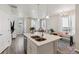Open-concept kitchen and living space with an island, stainless steel appliances, and natural lighting at 1954 S Poplar Ct, Denver, CO 80224