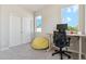 Home office features a desk, chair, windows, and a closet with sliding doors at 1954 S Poplar Ct, Denver, CO 80224